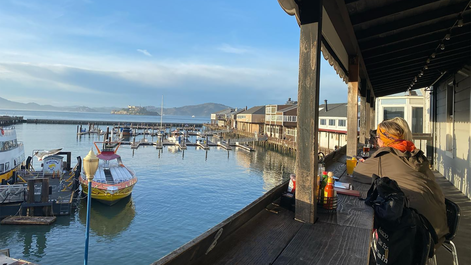 people dining with a view of the harbor